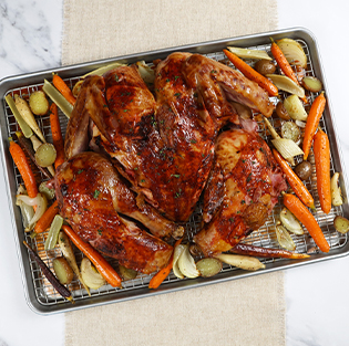 roasted chicken and vegetables on a sheet pan and rack